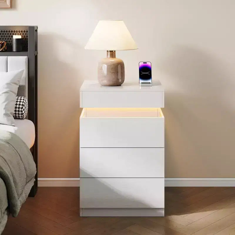 Designed for everyday convenience, this Nightstand with Built-In Charging Station and LED Lighting, 3-Drawer Sliding-Top Modern Bedside Table,.